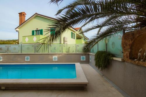 a house with a swimming pool in front of a house at Villa Medusa in Lucija