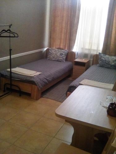 a living room with a couch and a bed at Fazenda in Sumy