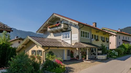 ein großes Haus mit Balkon auf einer Straße in der Unterkunft Hotel Steffl Garni in Ruhpolding