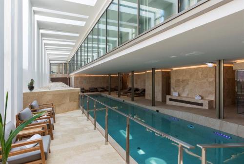 a swimming pool in a building with a swimming pooliterator at The Phoenicia Malta - The Leading Hotels of the World in Valletta