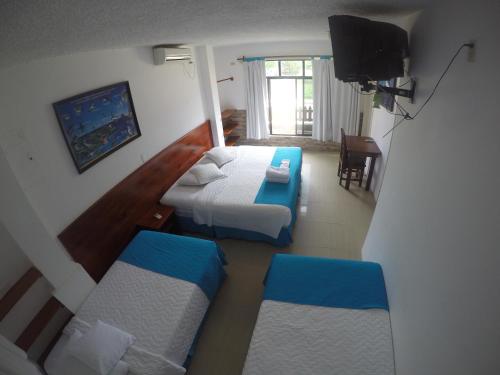 Postel nebo postele na pokoji v ubytování Hotel LA GRAN TORTUGA - ᯤ STARLINK