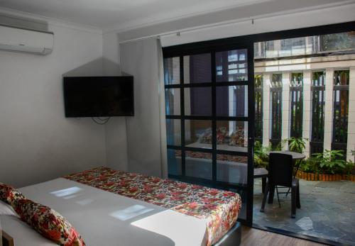 Un pat sau paturi într-o cameră la Hotel Poma Rosa