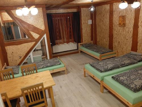 
a room with two bunk beds and a table at Atpūtas vieta Buki in Ventspils
