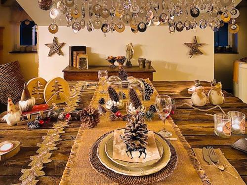 a wooden table topped with plates and wine glasses at Thermes Oppidum in Theux