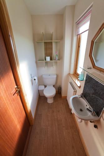 a bathroom with a toilet and a sink at Ard Garraidh in Ardersier
