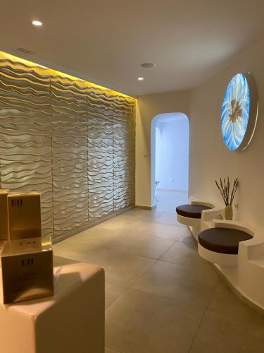 a room with two toilets and a large window at Absolute Mykonos Suites & More in Mikonos