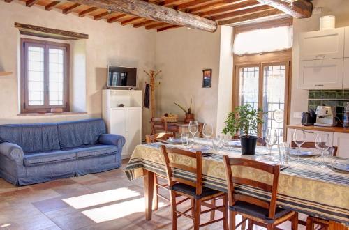 a living room with a table and a blue couch at Il Fienile in Figline Valdarno