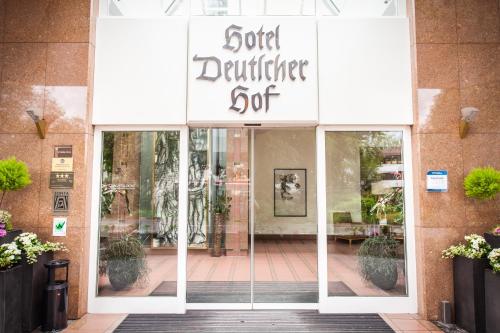 a store front door with a sign for a gold gathering spot at Hotel Deutscher Hof in Trier