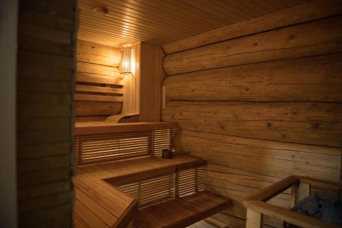 a sauna with wooden walls and benches in a cabin at Adele in Mizhhirʼʼya