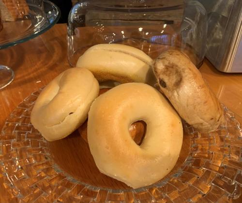 a plate of donuts and bagels on a table at The Inn at Longshore in Westport