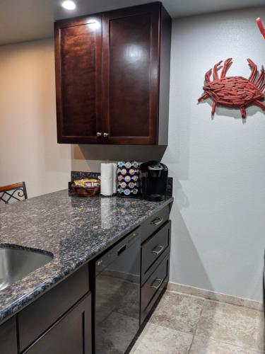 a kitchen with a counter top and a crab on the wall at Gulf View, Flip Flop Oasis GVR06432 in Galveston