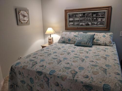 a bedroom with a bed with a quilt on it at Gulf View, Flip Flop Oasis GVR06432 in Galveston