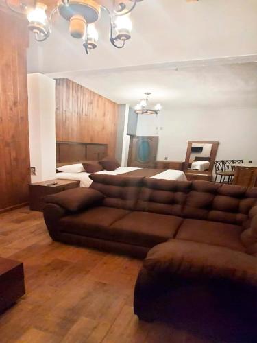 a living room with a couch and a bed at Hotel Suites La Fortuna in Mazamitla
