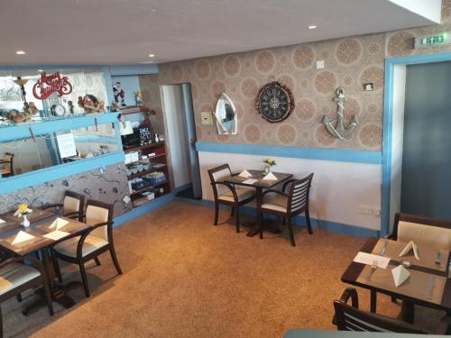 a dining room with tables and chairs in a restaurant at Marine Hotel in Buckie