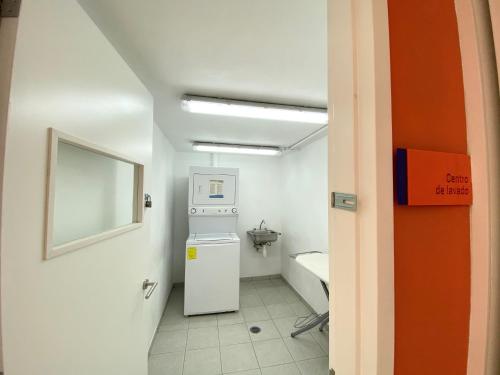 a small bathroom with a refrigerator and a sink at Hotel Star Express Puebla - Central CAPU in Puebla