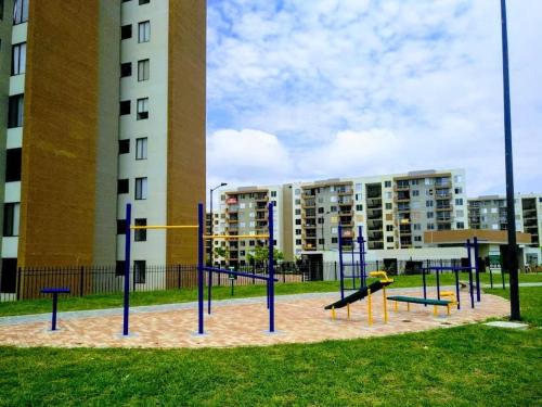 an empty playground in front of a building at PeñalisaKapoSalSar in Girardot