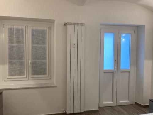 a white room with two windows and a door at Manzoni 2 in Turin
