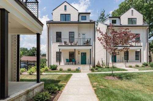 a large white house with a porch and a yard at Brand New Luxury Home near Downtown in Nashville