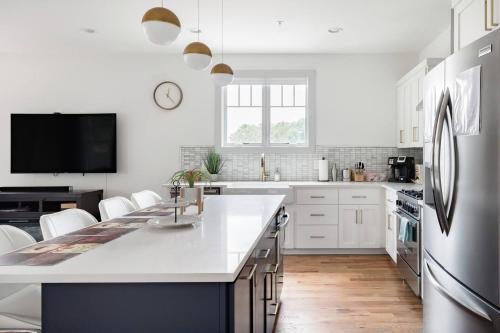 a kitchen with white cabinets and a large white counter top at Brand New Luxury Home near Downtown in Nashville