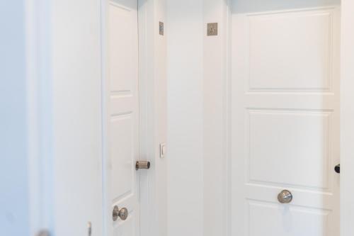a white closet with white doors in a room at Debambú Suites in Málaga