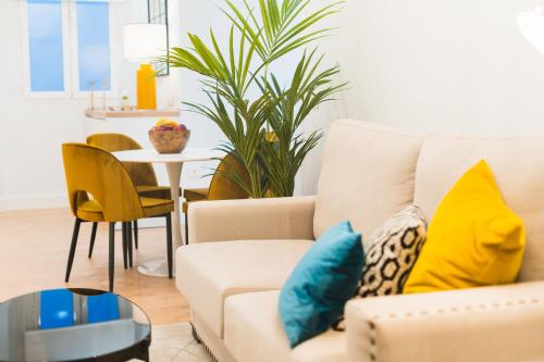 a living room with a couch and a table at Debambú Suites in Málaga