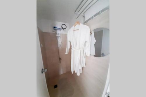 a white robe hanging in a hospital hallway at Cebu City Apartment - Mabolo Gardens in Cebu City