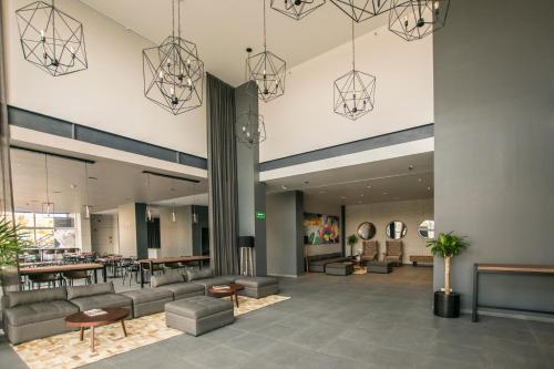 a lobby of a hotel with couches and tables at Bedford Hotel in Querétaro
