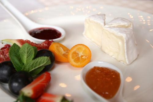 a plate of food with cheese and fruit and sauce at Gasthof Post in Rennweg