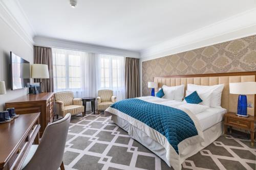 a hotel room with a bed and a desk at Palace Art Hotel Pezinok in Pezinok