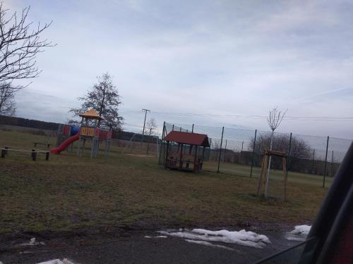 a park with a playground with a slide at Am Schwielochsee 2 in Speichrow