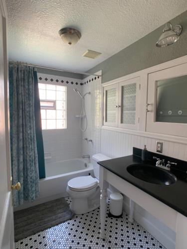 a bathroom with a white toilet and a sink at Private Room in West Highlands House in Denver