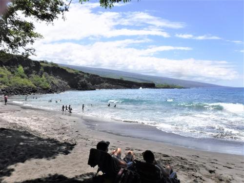 a group of people sitting on the beach at Ocean View Paradise! in Hawaiian Ocean View