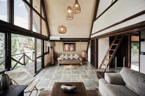 a living room with a couch and a table at LOGIN OKINAWA -soil- in Onna