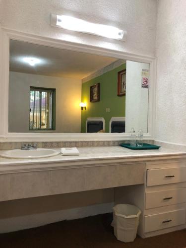 a bathroom with a sink and a large mirror at HSE Economy in Ciudad Madero