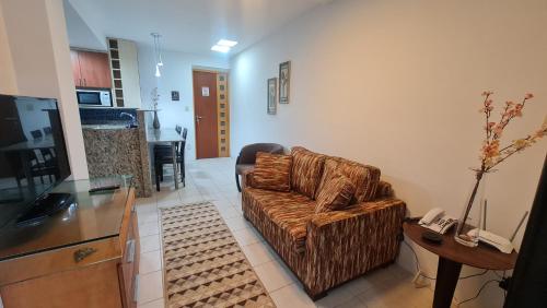 a living room with a couch and a table at Paraíso do Sul Recife in Recife