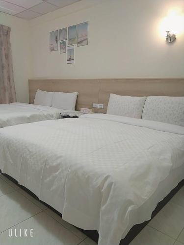 Postel nebo postele na pokoji v ubytování Zhiben hotspring Heping Guesthouse