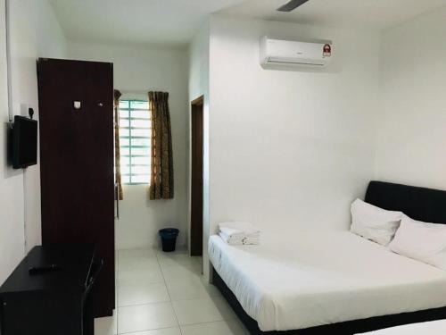 a hotel room with two beds and a window at Motel Fasa2B in Seri Manjung