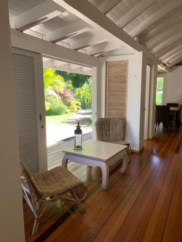 a living room with a table and a chair at Moorea Beach Lodge in Moorea