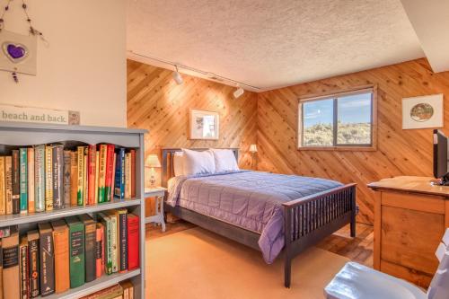 a bedroom with a bed and a book shelf with books at Osborne Beach House MCA 139 - Meredith Lodging in Manzanita