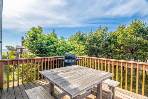 a wooden picnic table on a wooden deck at Osborne Beach House MCA 139 - Meredith Lodging in Manzanita
