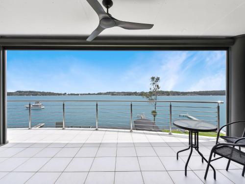 a view of the water from the balcony of a house at Sealand Lake House Stunning Absolute Waterfront in Fishing Point