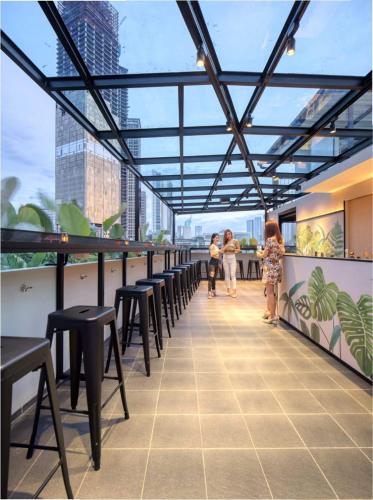 a view from the roof of a building with tables and chairs at Cool Living in Jakarta