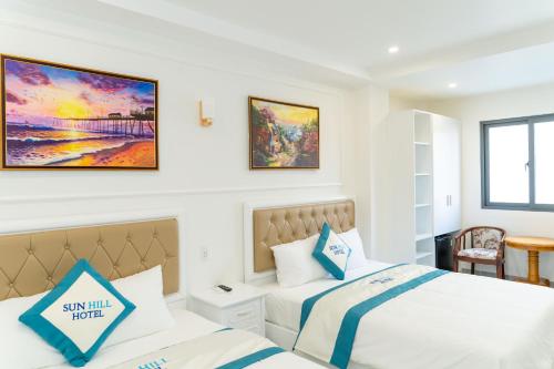 a hotel room with two beds and a window at Sun Hill Hotel in Vung Tau