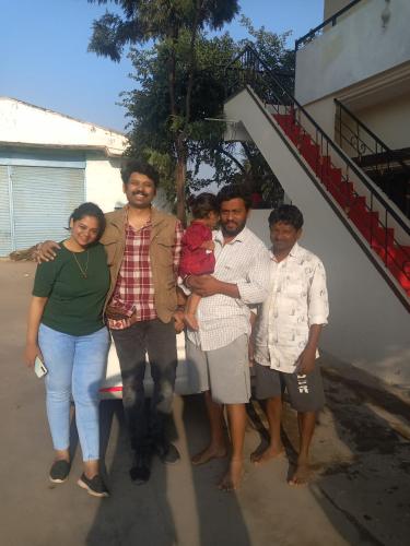 a group of people standing in front of a house at Krishna Homestay Hampi in Hampi