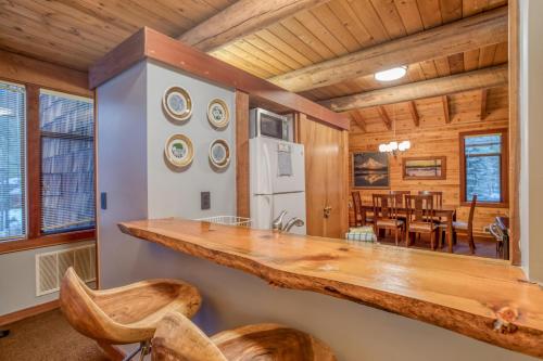 a kitchen with a counter and a dining room at Wildflower 46 - Meredith Lodging in Sunriver