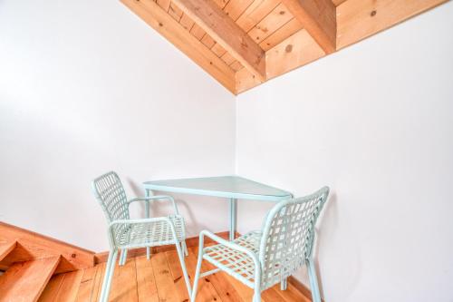 a table and chairs in a room with wooden floors at Wildflower 46 - Meredith Lodging in Sunriver