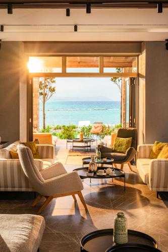 a living room with a view of the ocean at Mount Athos Resort in Ierissos