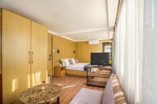 Habitación de hotel con cama y TV en Stilly Inn, en Pātan