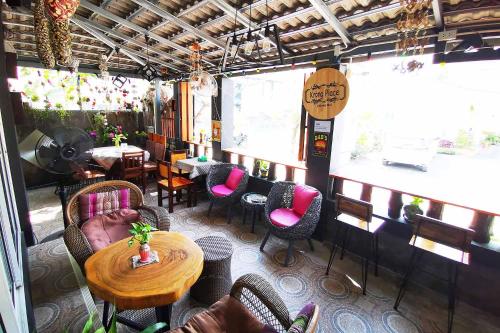 a restaurant with a table and chairs and tables and chairs at Krong House in Chiang Mai