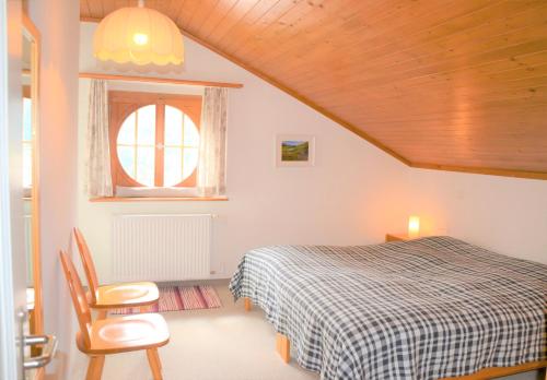 a bedroom with a bed and a window at Bisang R in Arosa